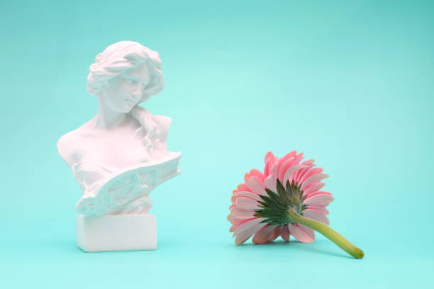 istock Female bust sculpure greek style with gerbera flower on blue background 1764901969