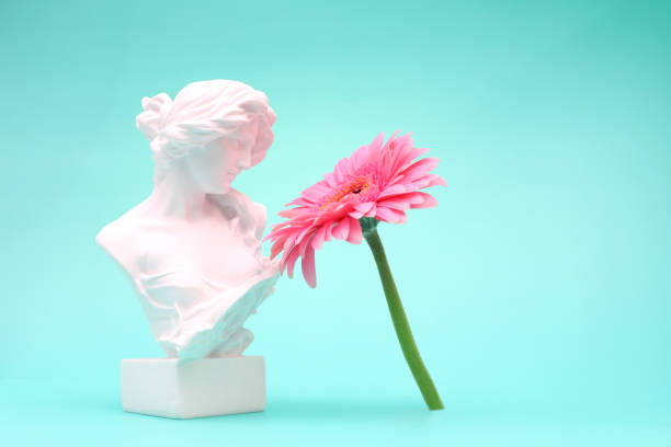 istock Female bust sculpure greek style with gerbera flower on blue background 1764901972