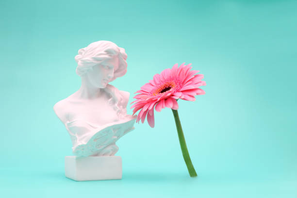 istock Female bust sculpure greek style with gerbera flower on blue background 1764901989
