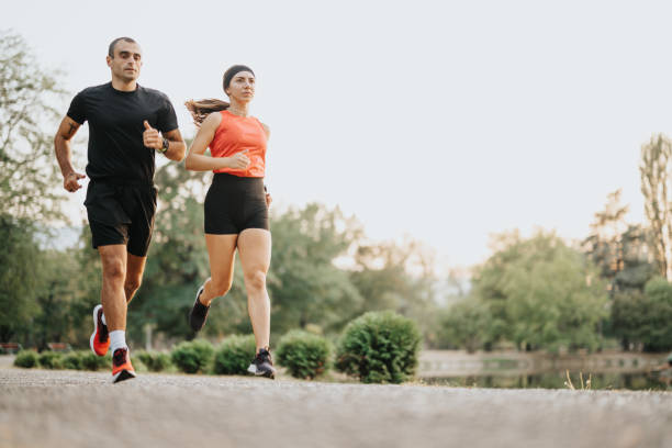 istock Two well-built runners jogging in park, training outdoors together. 1764908513