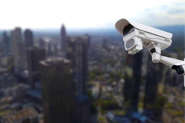istock CCTV Camera Operating with city in background. 1764928682