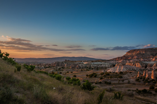 Rocky landscape in Cappadocia, Turkey. Travel in Cappadocia. Rocky summer landscape at sunset in Cappadocia Goreme