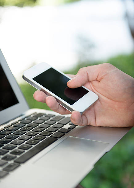 istock A close up of a person using a smart phone and laptop 176494201