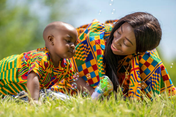 istock Little boy with his mother playing in the park with soap bubbles 1764942448