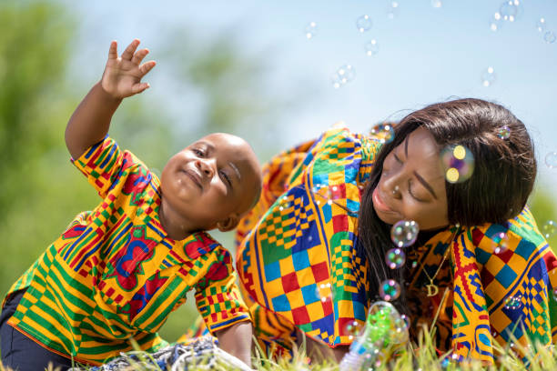 istock Little boy with his mother playing in the park with soap bubbles 1764942454