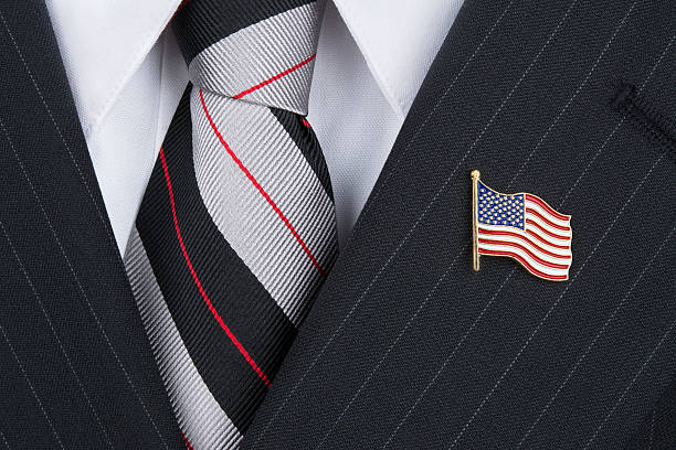 Politican wearing lapel pin A politician wearing an American flag lapen pin symbolizes patriotism. pin flag stock pictures, royalty-free photos & images