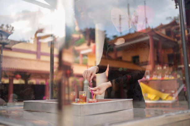 woman burning incense and praying