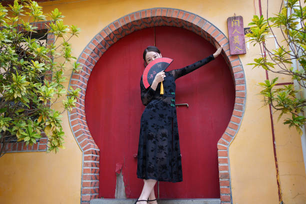Classical woman covering her face with fan