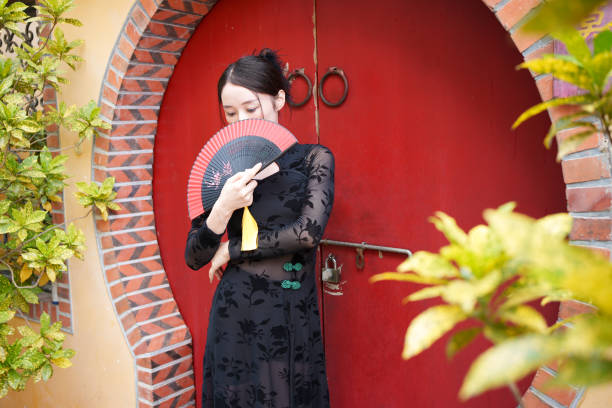 istock Classical woman covering her face with fan 1764970301