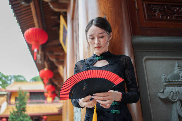 istock Classical woman holding paper fan 1764975752