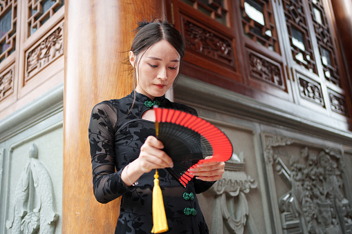 Classical woman holding paper fan