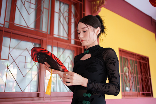 Asian woman holding fan