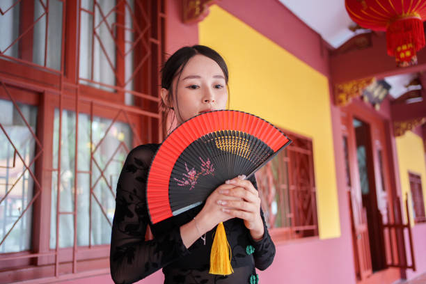 woman holding fan