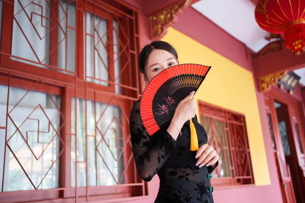 istock woman covering face with fan 1764986151
