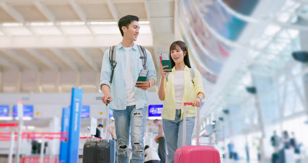 istock Couple happily chat at airport 1764989308