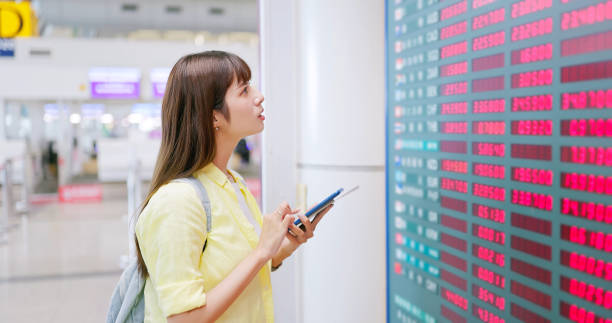 female look at exchange rate board