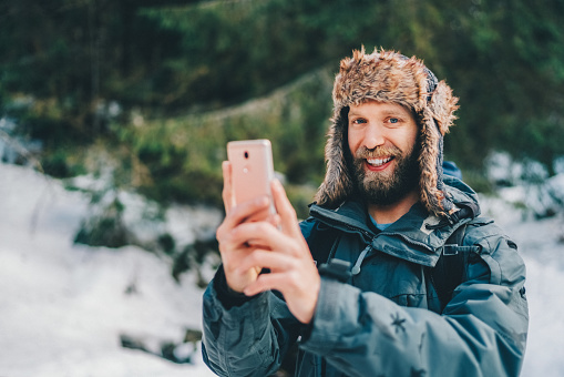 Explorer on winter hiking sharing his adventure on social media