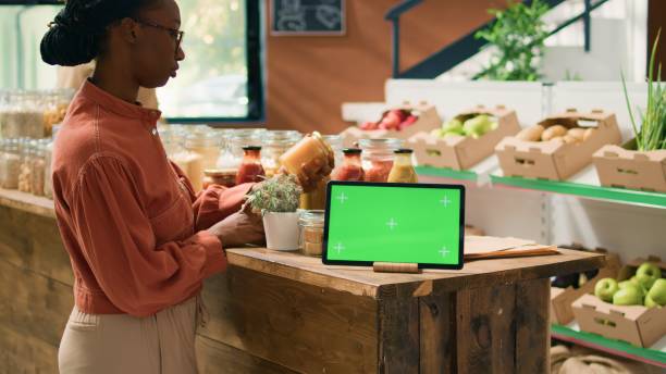 istock Greenscreen on gadget near woman 1765011939