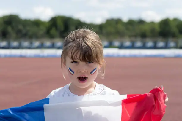 Pretty young girl supporting the French team in a sports tournament