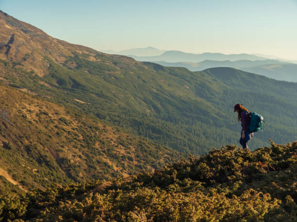 istock Going Down Hiker Tourist Woman With Backpack During Mountain Trekking 1765016218