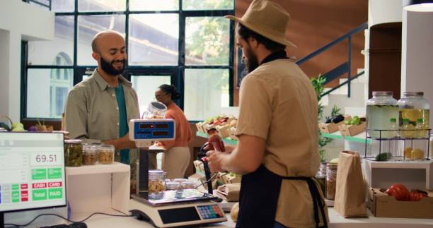 istock Merchant at checkout scanning goods 1765020116