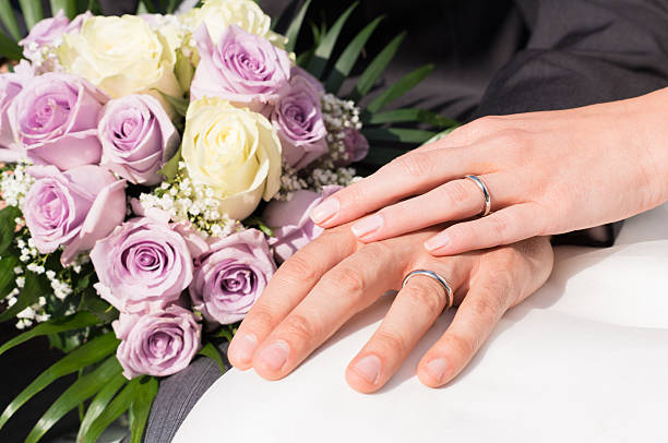 Hands With Wedding Rings Closeup Couple's Hands Wearing Wedding Ring And Holding Bouquet wedding ceremony formalwear people clothing stock pictures, royalty-free photos & images