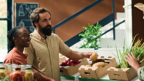 istock Merchant shows vegetables to clients 1765021220