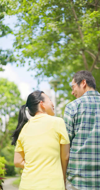 istock elder couple walking  in park 1765033964