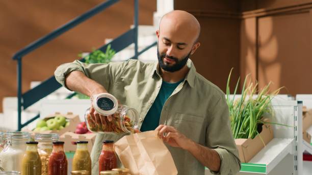 istock Young adult pouring pasta into bag 1765037168