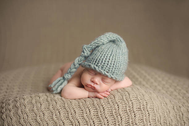 istock Preemie Newborn Boy Sleeping in Knit Hat 176505193
