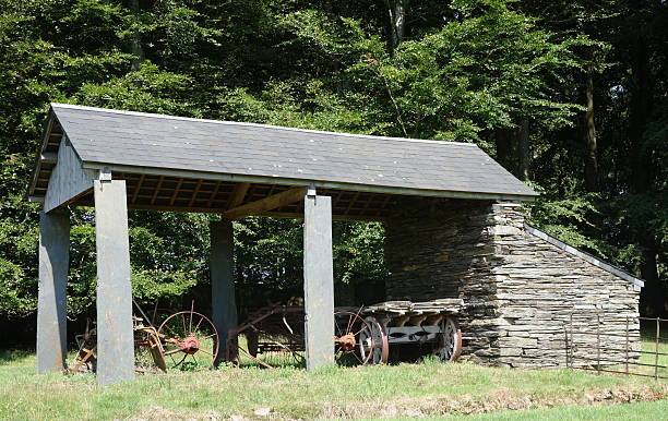 istock ancient slate built barn and farm machinery 176505715