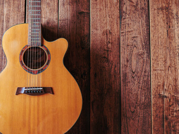 istock classical guitar on wooden background 1765073759