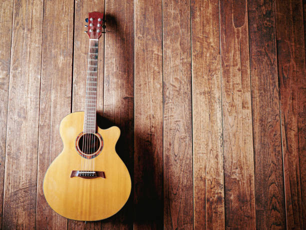istock classical guitar on wooden background 1765073766