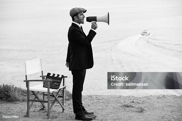 Mid Adult Man Directing Film In Outdoor Movie Set Stock Photo - Download Image Now - Retro Style, Old-fashioned, Megaphone