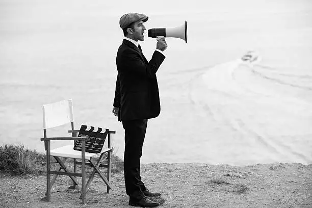 Photo of Mid Adult Man Directing Film In Outdoor Movie Set