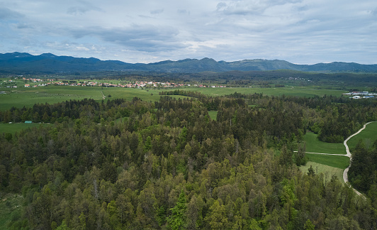 Aerial photo of a rural area in Slovenia taken by drone camera from above in a cloudy spring day