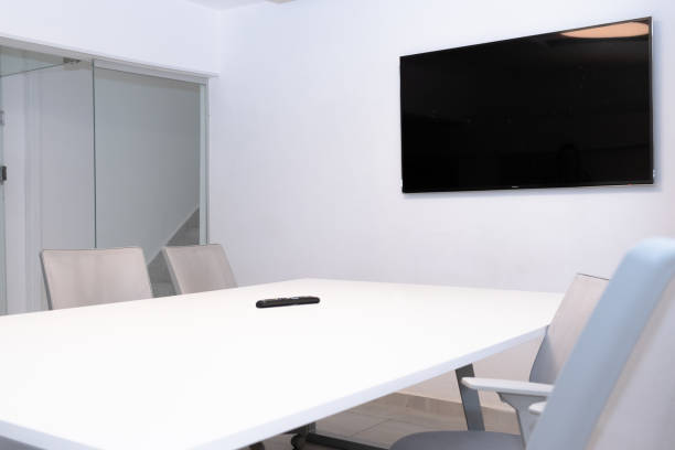 istock Meeting room in workspace. Office concept. LED TV Remote control on table. 1765132870