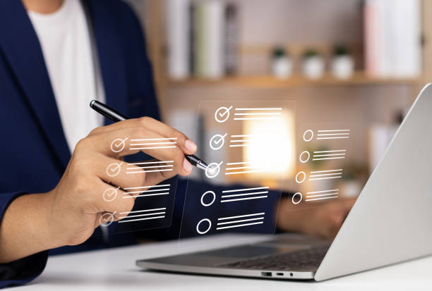 istock Digital Checklists for efficient business management, Businessman touching marking on checklist guide to paperless assessment and Future Success, Streamlining operations with online surveys. 1765137915