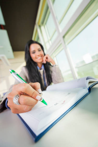 istock Happy businesswoman writing in notebook on seminar 1765154781