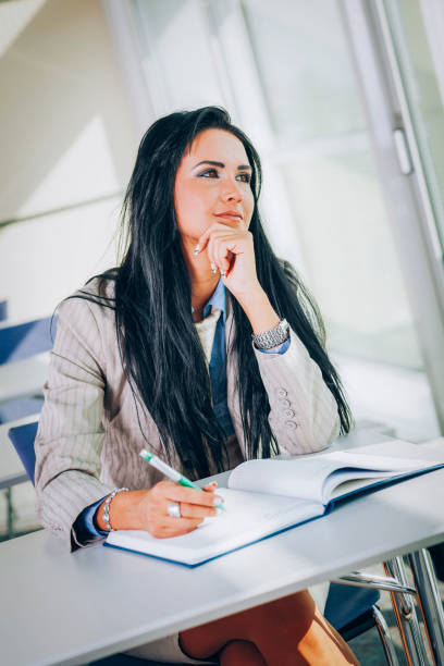 istock Happy businesswoman writing in notebook on seminar 1765155872