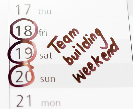 Note in felt-tip pen reminds you about a team building weekend coming up.