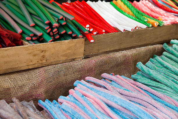 Little girl is taste candy on a stick