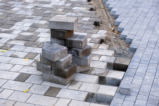 Stacks of new paving stones ready for laying on a pedestrian street