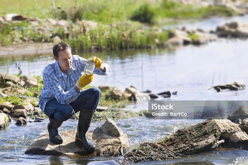 Hydro biologist testing quality of water Man testing quality of natural water Water Stock Photo