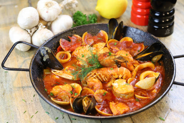 Spanish dish Zarzuela with seafood in soft tomato and white wine sauce stock photo