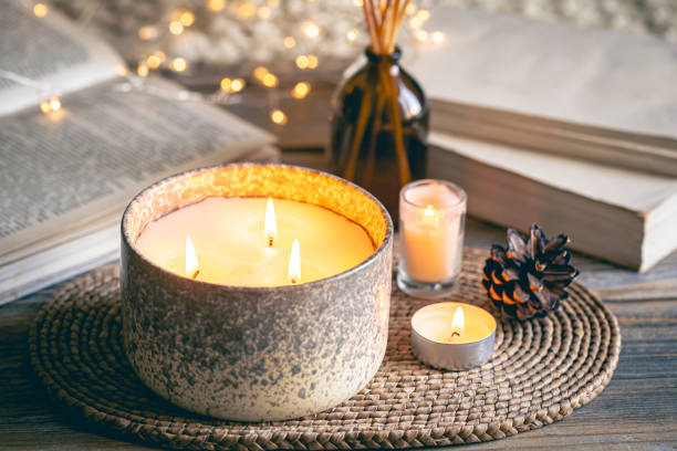 istock Cozy winter composition with candles on a blurred background with books. 1765222271