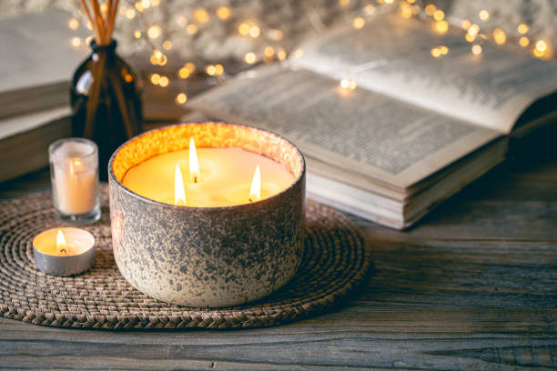 istock Cozy winter composition with candles on a blurred background with books. 1765222281