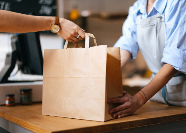 istock Unrecognizable Female Employee Giving Packed Order To A Customer 1765227166