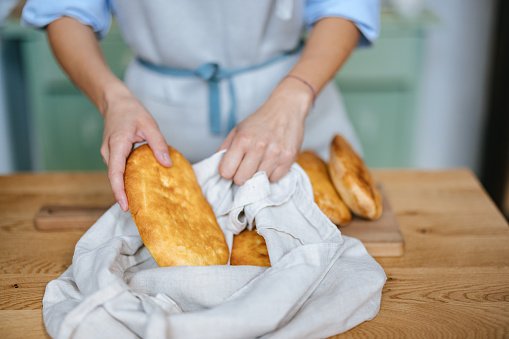 Hands breaking Fresh homemade Baked Japanese Soft and Fluffy Bun loaf of Bread or shokupan bread for Breakfast. Bakery Concept Picture. Copy Space for Text