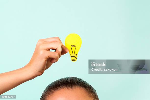 Woman Thinking Concept With Hand Holding Light Bulb Stock Photo - Download Image Now
